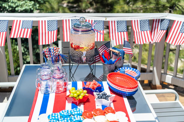 istock Table with food and drinks set for celebrating July 4th on the back patio. 1169793196