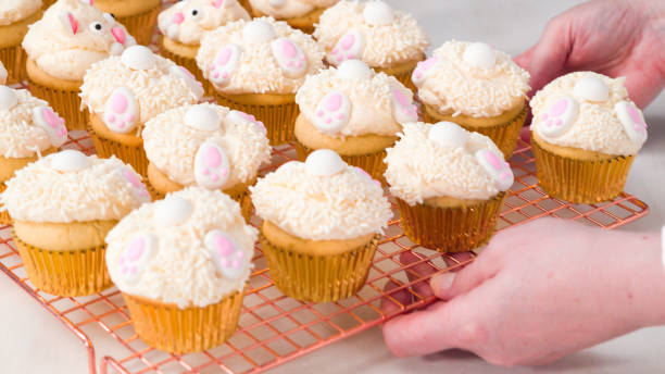 istock Decorating vanilla cupcakes with white buttercream frosting 1169793352