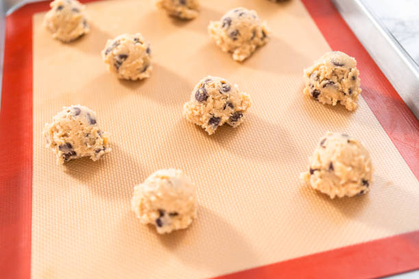 istock Homemade chocolate chip cookies dough scoops on a baking sheet 1169793373