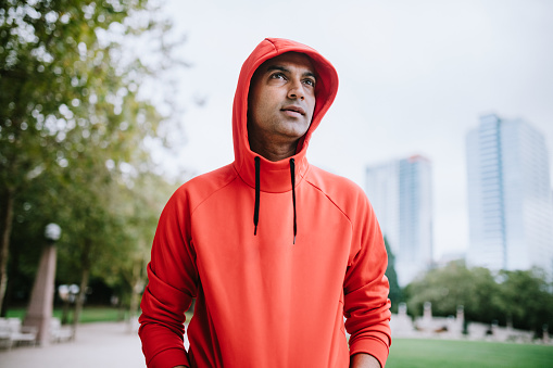 An Indian man goes for a morning run in the city of Bellevue, Washington, USA. Bellevue's Downtown Park is a perfect place for a jog or other exercise, with open footpaths and city skyline views.