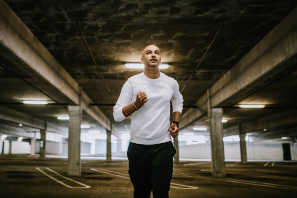 istock Running Indian Man in Parking Garage 1169794326