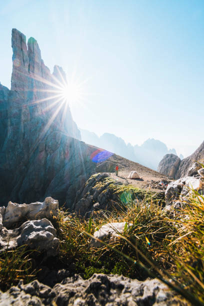 istock Distant view of camper with tent in mountains 1169797724