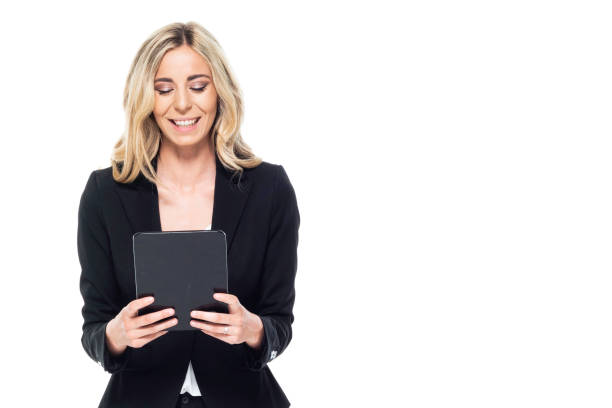 istock Attractive blond businesswoman - holding tablet, looking at digital tablet 1169799604