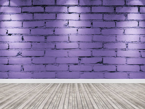 istock Brick wall with spotlight. Interior violet background wooden floor 1169800801