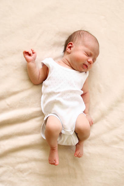 istock Cute newborn child is sleeping on a blanket. 1169801933