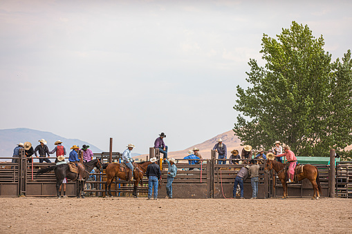 A group of cowboys getting ready to ride at a rodeo
