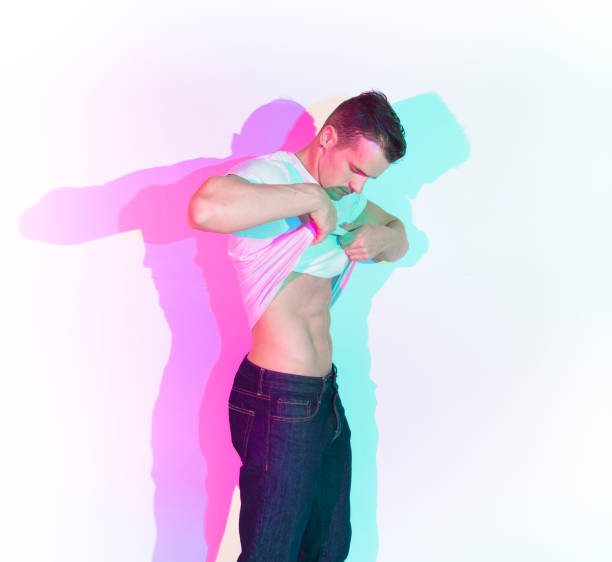istock Handsome man taking off his white shirt 1169803699