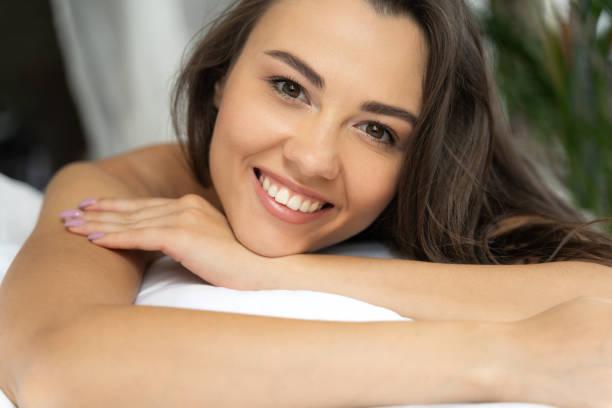 istock Joyful young woman lying in her bed 1169804648