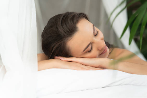 Charming young woman lying in bed and smiling