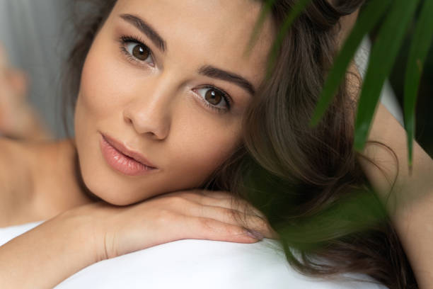 istock Attractive young lady looking at camera and touching her hair 1169804683