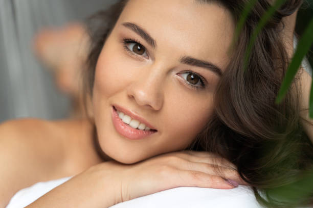 istock Cheerful young lady resting her chin on hand 1169804706