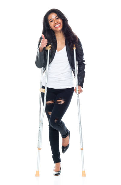 istock Bautiful woman wearing a leather jacket and using crutches 1169805865