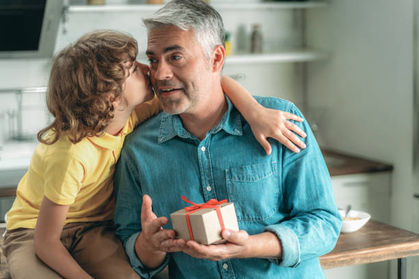 istock Son kissing father and givind present box 1169808672