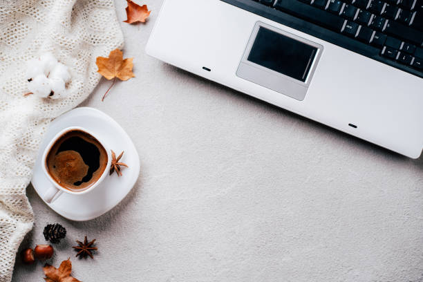 istock Autumn mood. Knitted plaid, coffee and laptop 1169809614