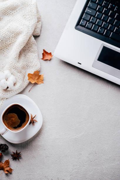 istock Autumn mood. Knitted plaid, coffee and laptop 1169809676