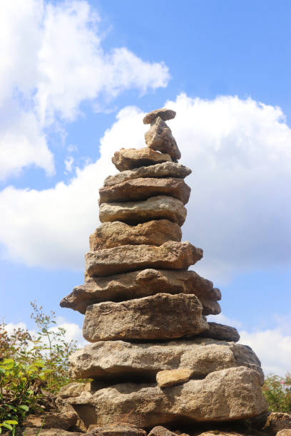 close-up of stapled stones in front of blue and white sky, low angle view