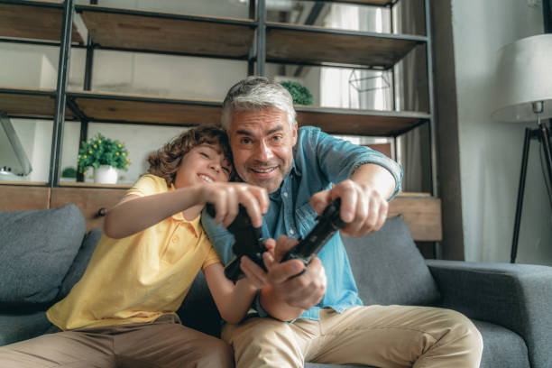 istock Mature father with son playing in video games 1169810065