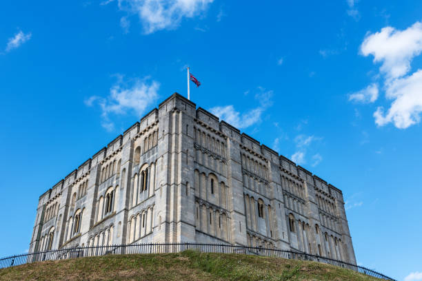 Low-angle view of the medieval castle of Norwich against a cloudy blue sky, Norfolk, East Anglia.