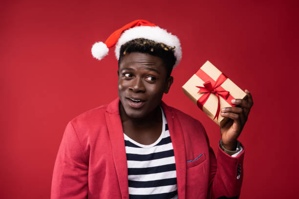 istock Joyful man is holding gift box with red ribbon 1169816271