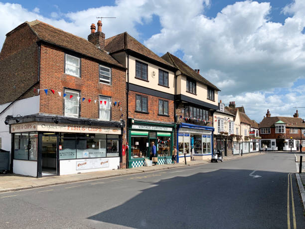 Sandwich High Street in Kent, UK Sandwich, United Kingdom - August 20th, 2019 :  The High Street through the medieval town of Sandwich in Kent, UK.  The historic town centre has been preserved and protected.  Sandwich was once a major sea port but it is now two miles from the coast following the silting up of the Wantsum Channel. sandwich kent stock pictures, royalty-free photos & images