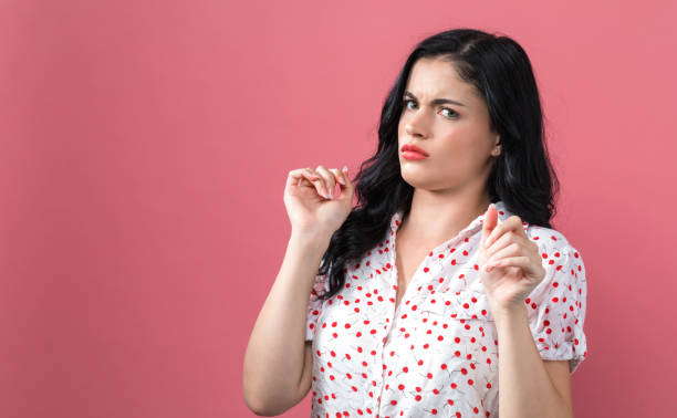 istock Disgusted face expression with young woman 1169817535