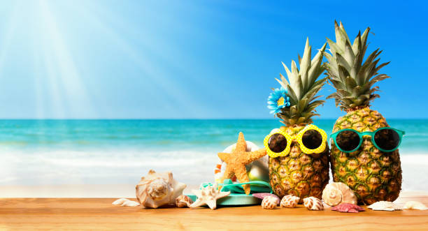 istock Pineapples with starfish on the beach 1169817649