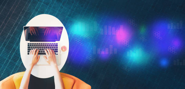 istock Digital graphs and hexagon grids with person using a laptop 1169818182