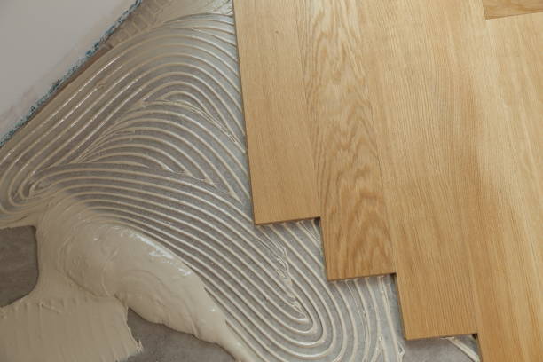 istock Construction in a renovated room installation of parquet 1169819859