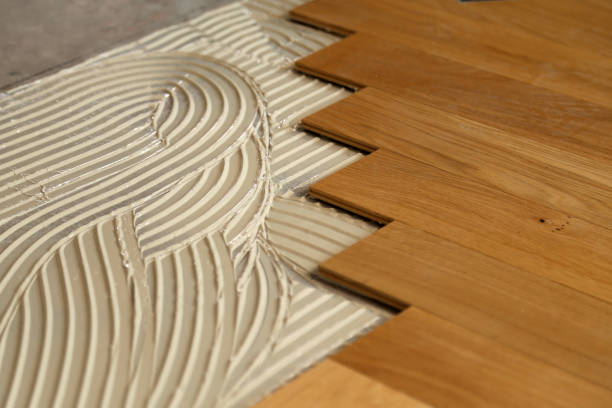istock Construction in a renovated room installation of parquet 1169819879