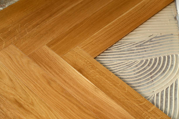 istock Construction in a renovated room installation of parquet 1169819940