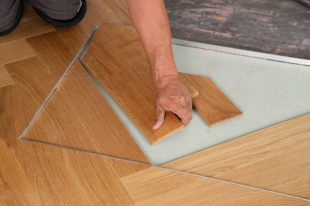 istock Worker laying parquet flooring. Worker installing wooden laminate flooring 1169819971