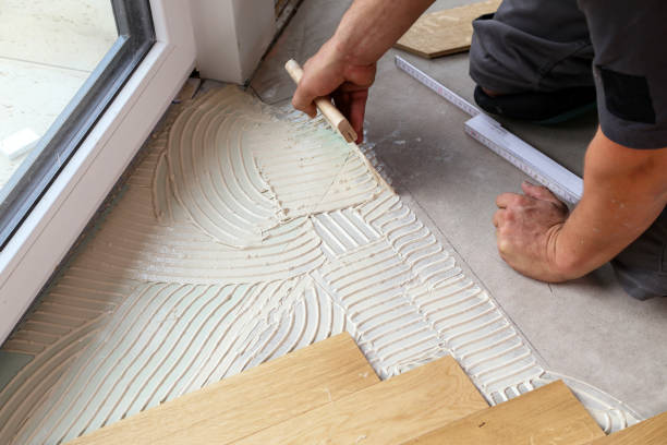 istock Worker laying parquet flooring. Worker installing wooden laminate flooring 1169819997