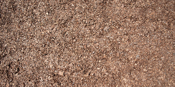 Background of seamless tiling wood chips used for safety in toddlers playgrounds.