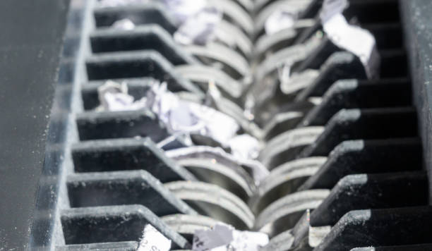 istock closeup view of office paper shredder teeth 1169822746