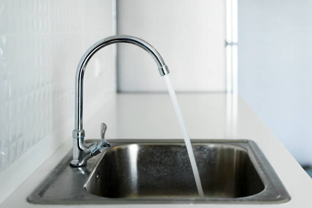 istock steel sink in modern white kitchen clean interior design 1169823788