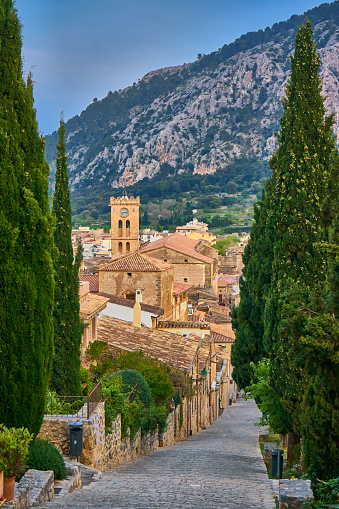 View At carrer del Calvari At Blue Hour With Typical Old Houses And City Center Pollença, old village on the island Palma Mallorca, Spain