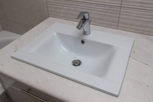 istock Ceramic white washbasin with stainless faucet 1169834886