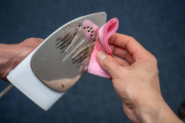 Using a highly heated iron Removal of melted fibers and scrap hardened plastic on the soleplate. Cleaning the surface of the iron. Prevention of the soleplate surface from becoming scratched or corroded. Household concept scuff marks photos stock pictures, royalty-free photos & images