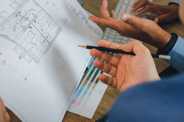 istock architect interior designer working with house drawing plan & color swatch 1169834980