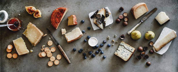 istock Variety of wine snacks, jam and cheeses over grey background 1169835993