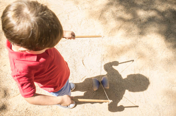 istock Little boy learning to use diabolo i the park 1169840156
