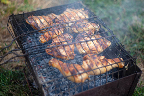 istock barbecue fried chicken thighs with smoke 1169842144