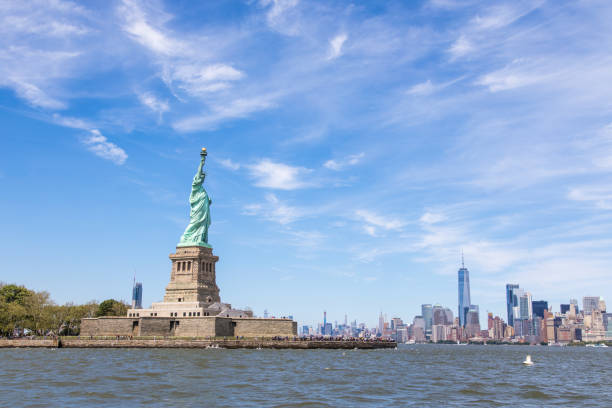 istock Statue of Liberty and NY skyline in background 1169845457