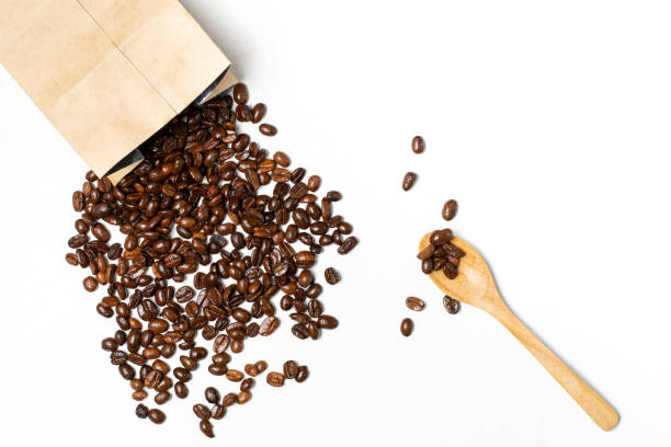istock Coffee beans from envelopes and measuring spoons on a white background 1169845487