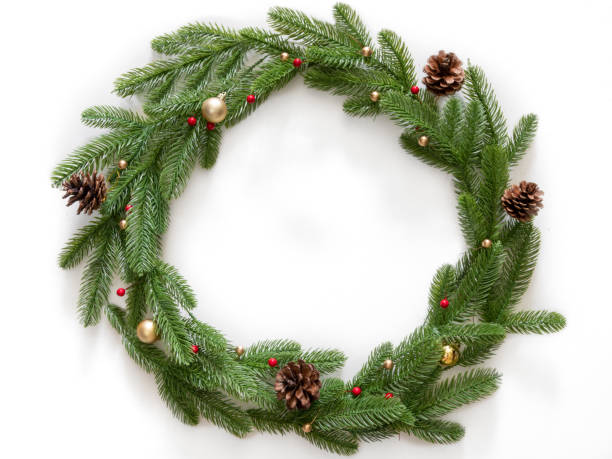 istock Christmas composition. Wreath made of christmas tree branches and pine cones with gold bubbles on white background. Flat lay, top view, copy space 1169849875