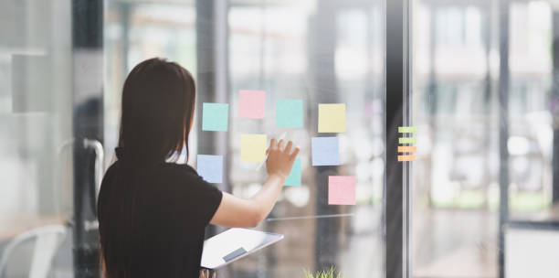 istock Designer collecting ideas from sticky notes 1169851989