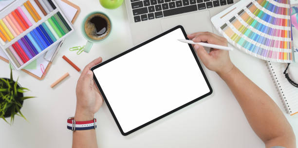 istock Top view of male graphic designer drawing on blank screen tablet 1169852007