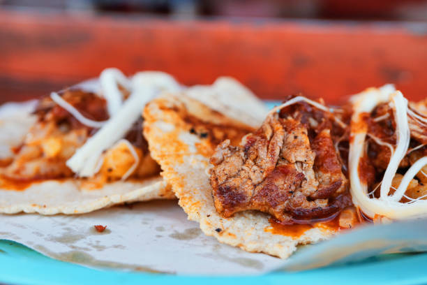 istock Delicious meat tacos with cheese and sauce 1169852023