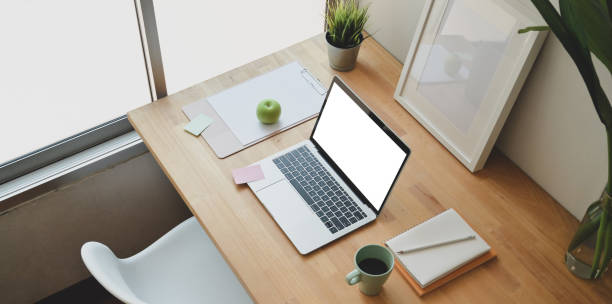 istock Minimal home-office with open blank screen laptop 1169852054