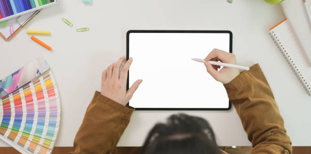 istock Female graphic designer sketching on blank screen tablet 1169852084